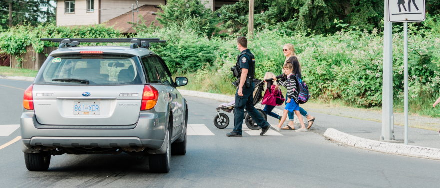 Car stopped for young family crossing street